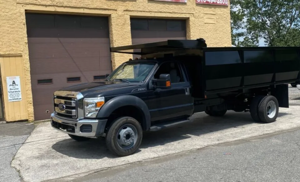 Black dump truck at TA Trucks Sales and Repairs in Delaware County, PA