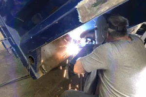 Mechanic from TA Trucks performing truck bed repairs in Delaware County, PA