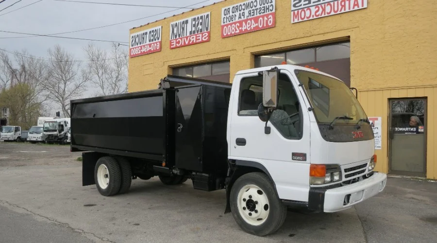 An Isuzu Truck in front of the TA Trucks building